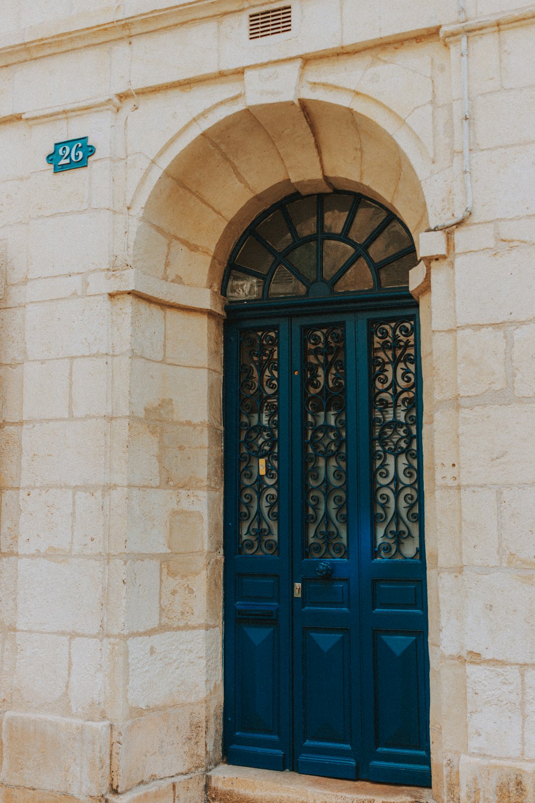 blue wooden door on beige concrete building