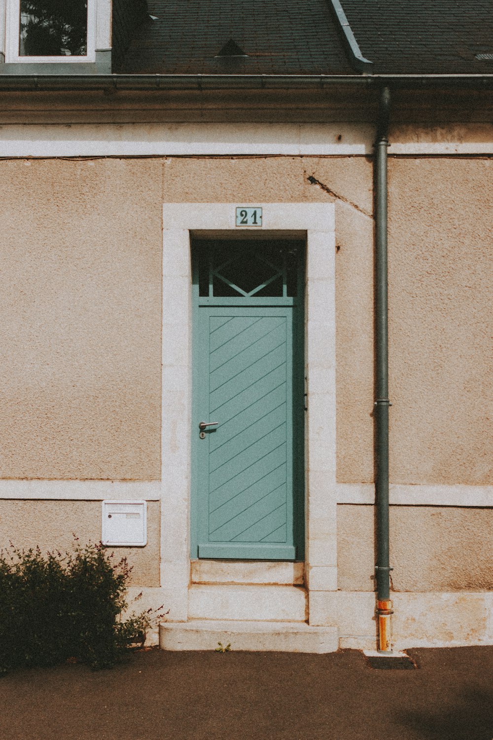 white wooden door on brown concrete wall