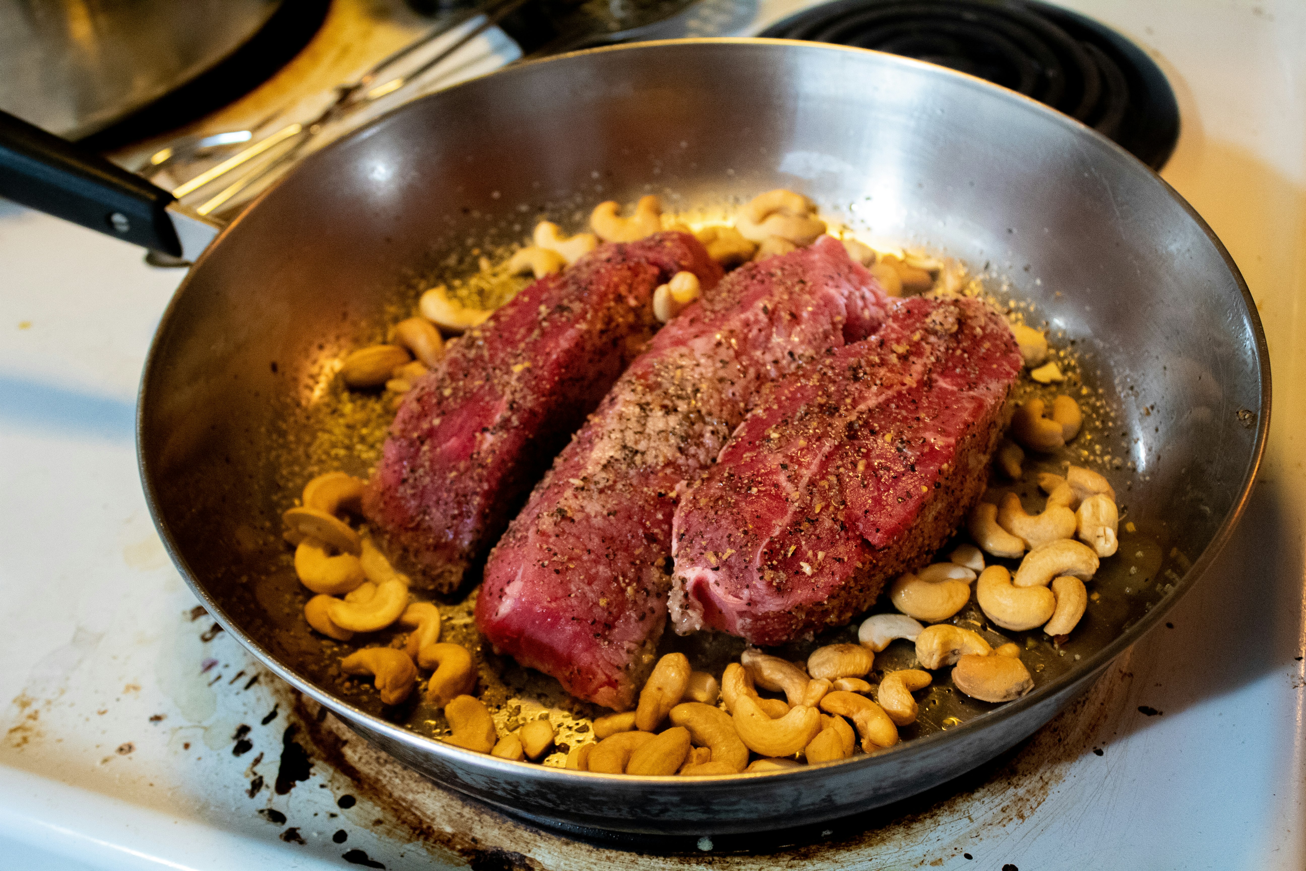 cooked meat on stainless steel bowl