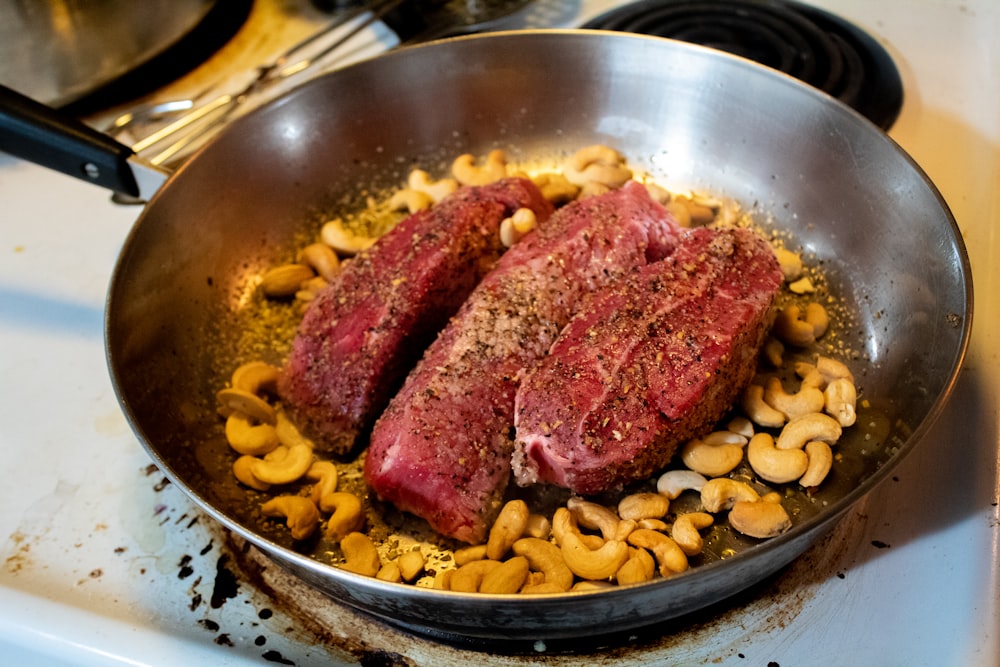 cooked meat on stainless steel bowl