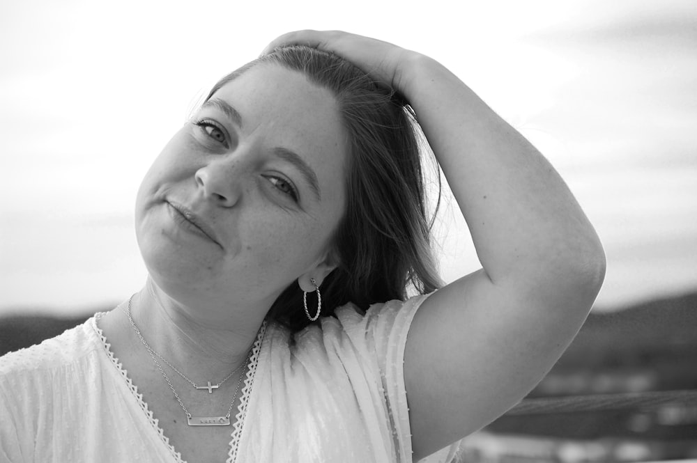 woman in white tank top wearing silver necklace