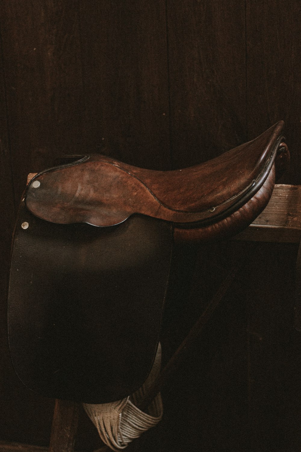 black leather heeled shoe on brown wooden table