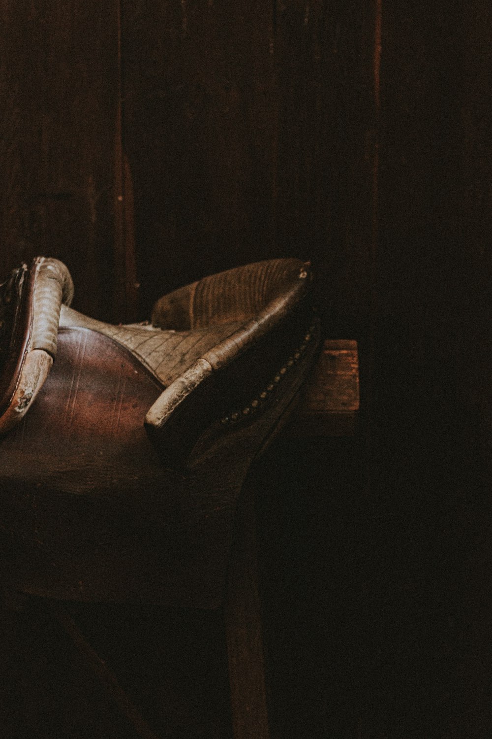 brown leather armchair with brown wooden frame