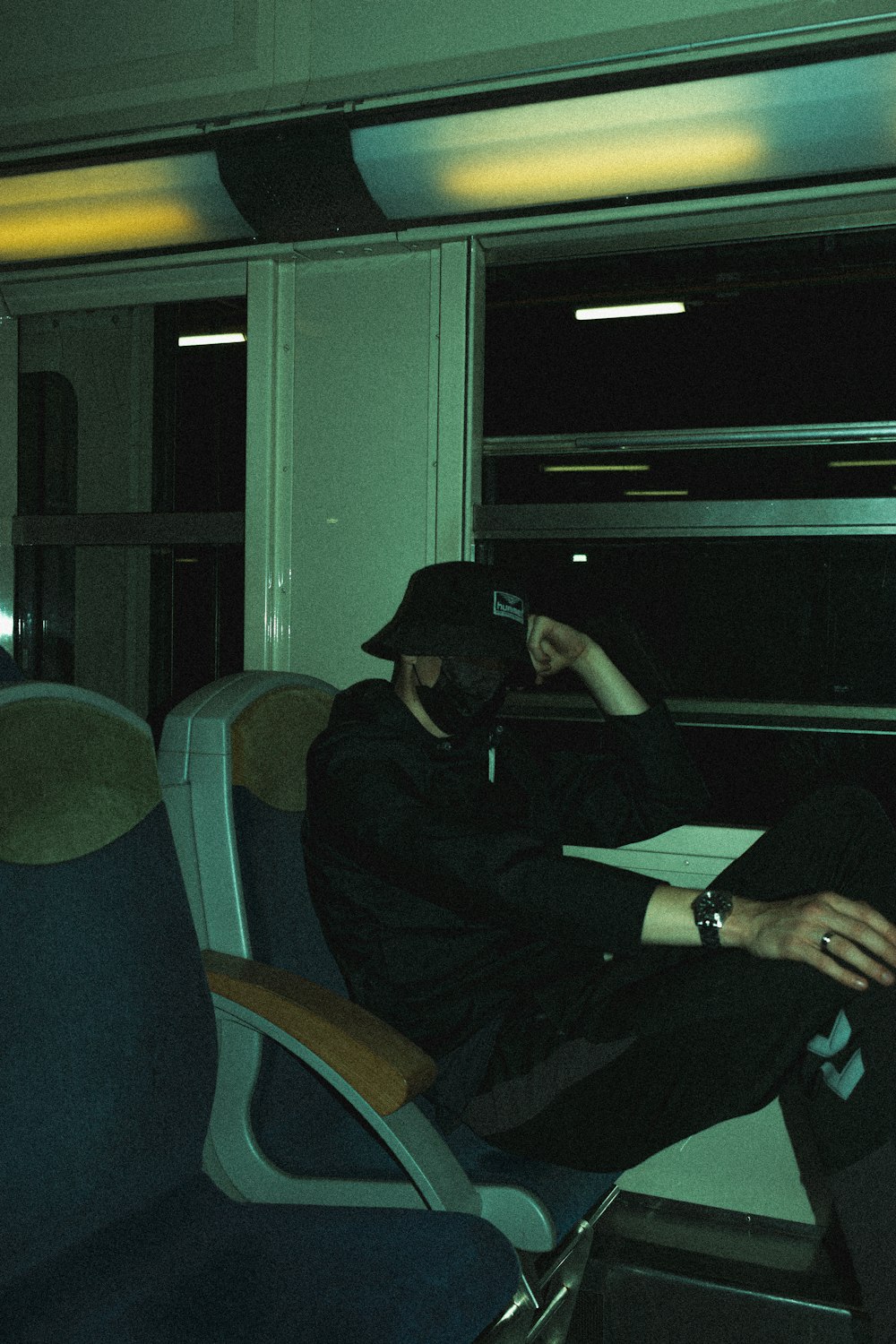 man in black jacket sitting on chair