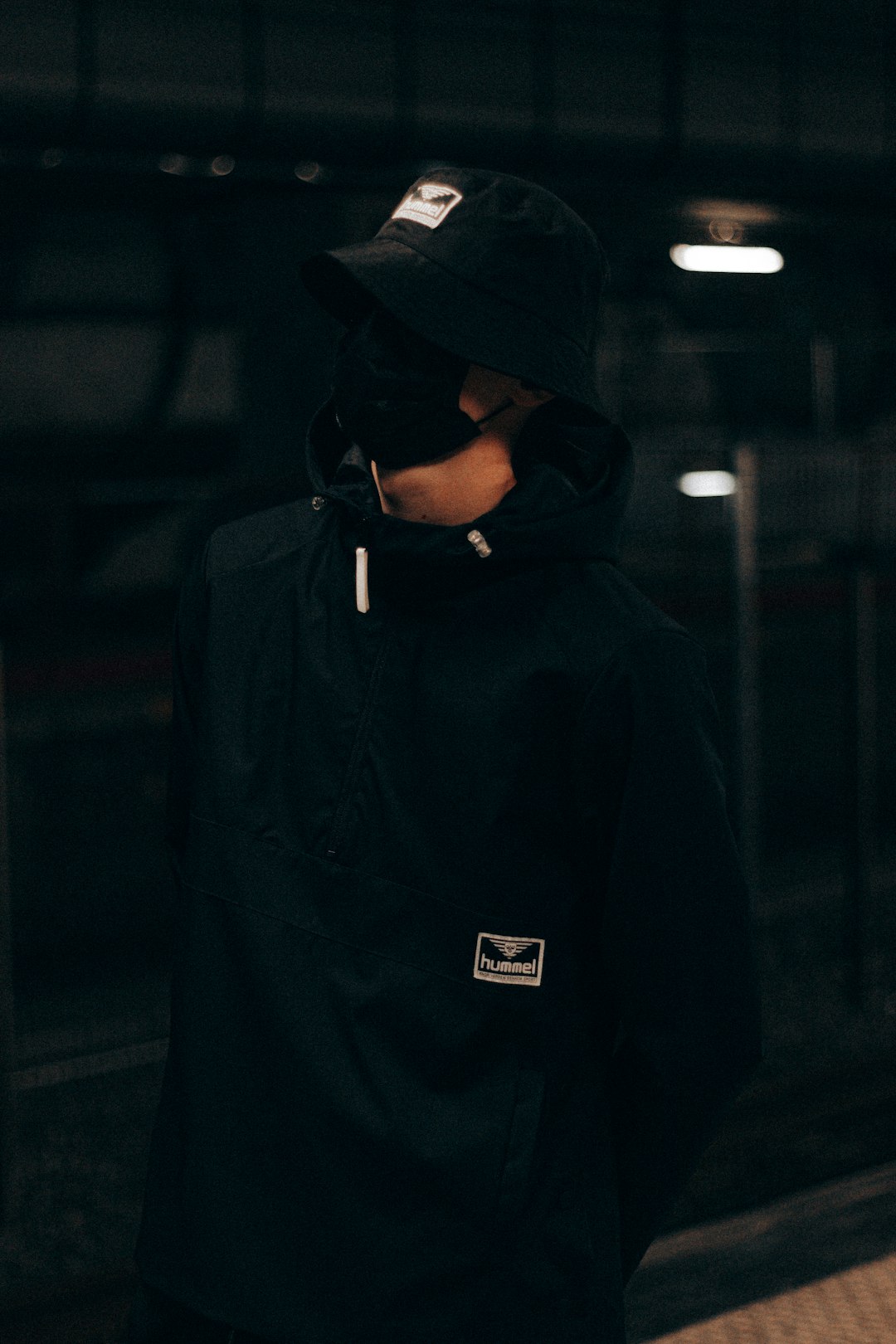 man in black hoodie and black cap