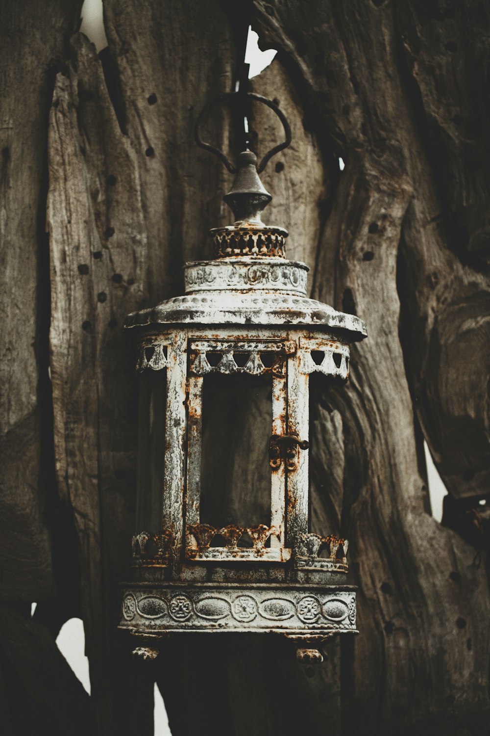 white and gold bell on brown wooden surface