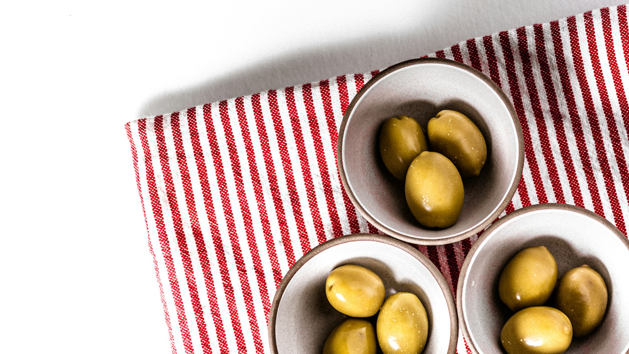Three ramekins of olives
