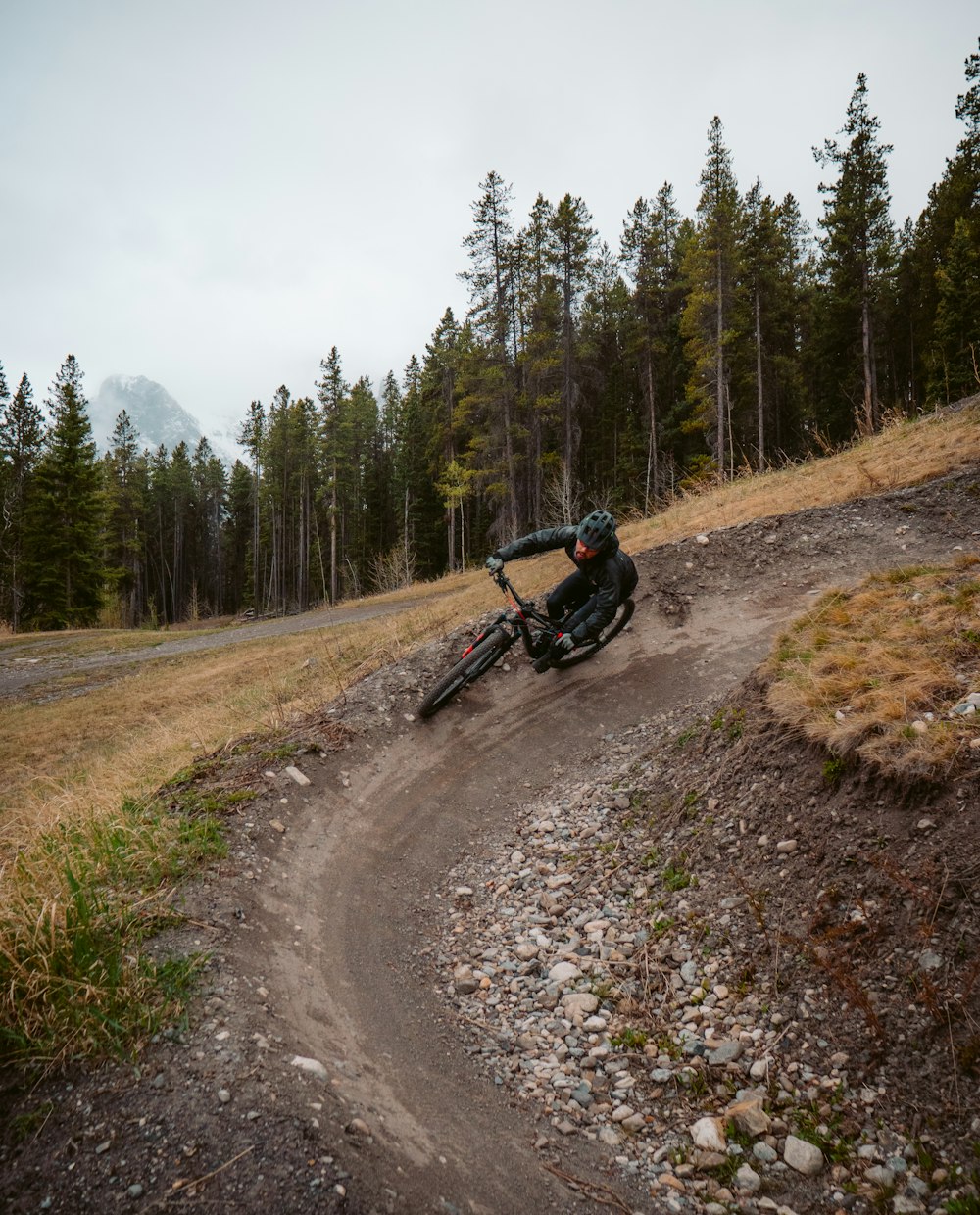 man riding motorcycle on dirt road during daytime