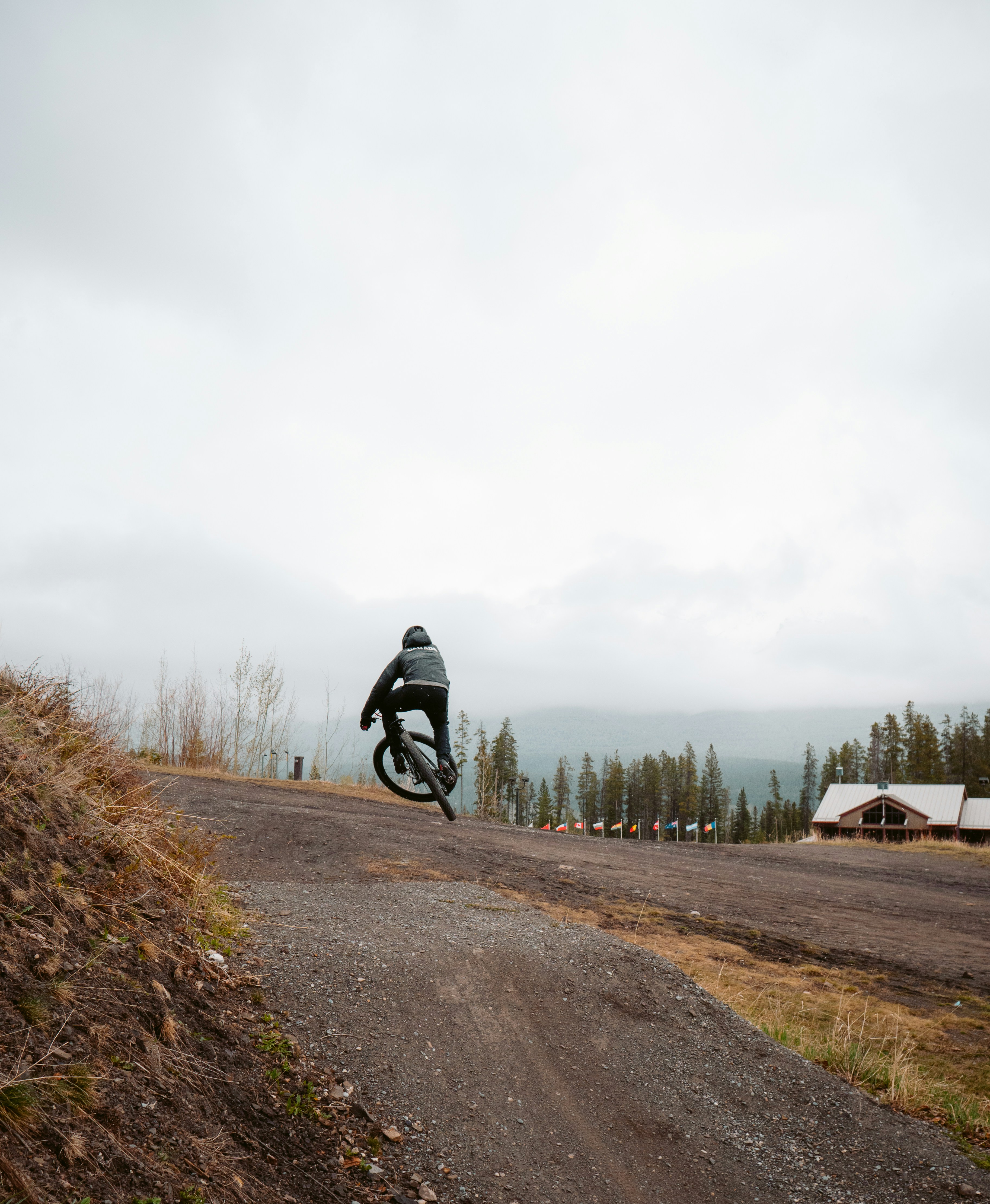 man in black jacket riding bicycle on road during daytime