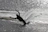 Close-up of a waterskier carving a perfect turn on pristine lake water.