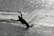 Close-up of a waterskier carving a perfect turn on pristine lake water.