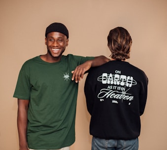 man in green crew neck t-shirt beside woman in black crew neck t-shirt
