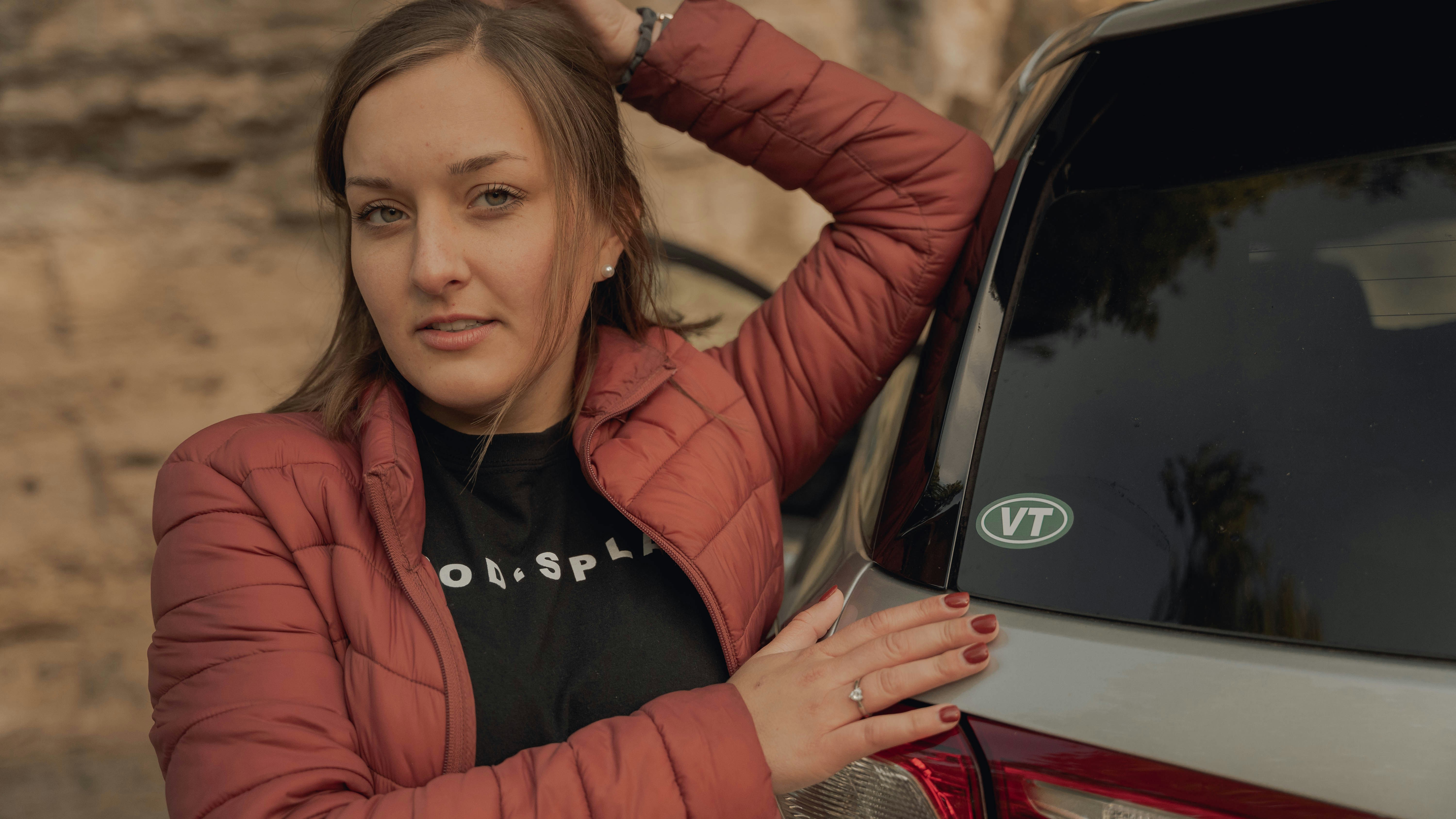 woman in red leather jacket beside woman in black shirt