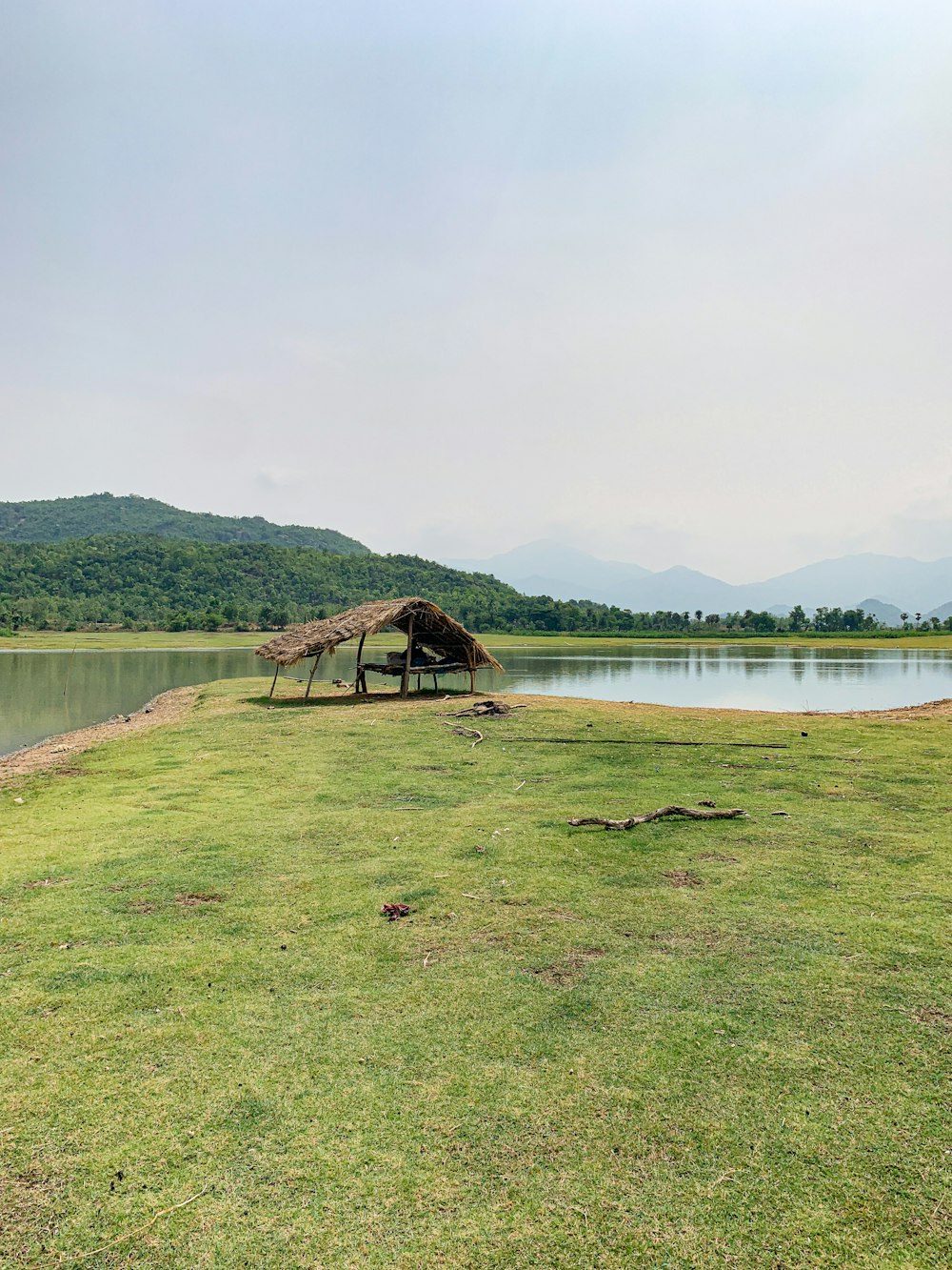 campo de grama verde perto do lago durante o dia