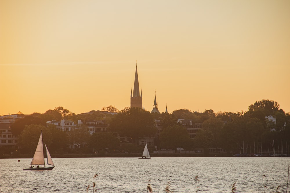 silhouette of building near body of water during sunset