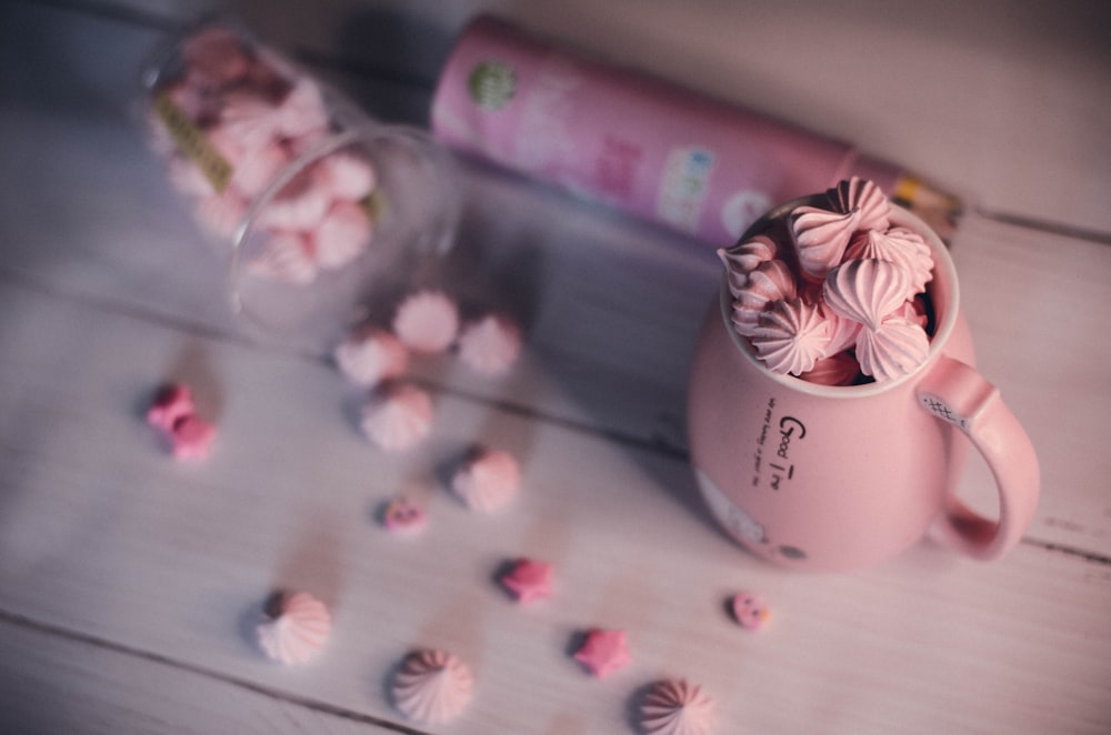 white ceramic mug on white and pink floral table cloth