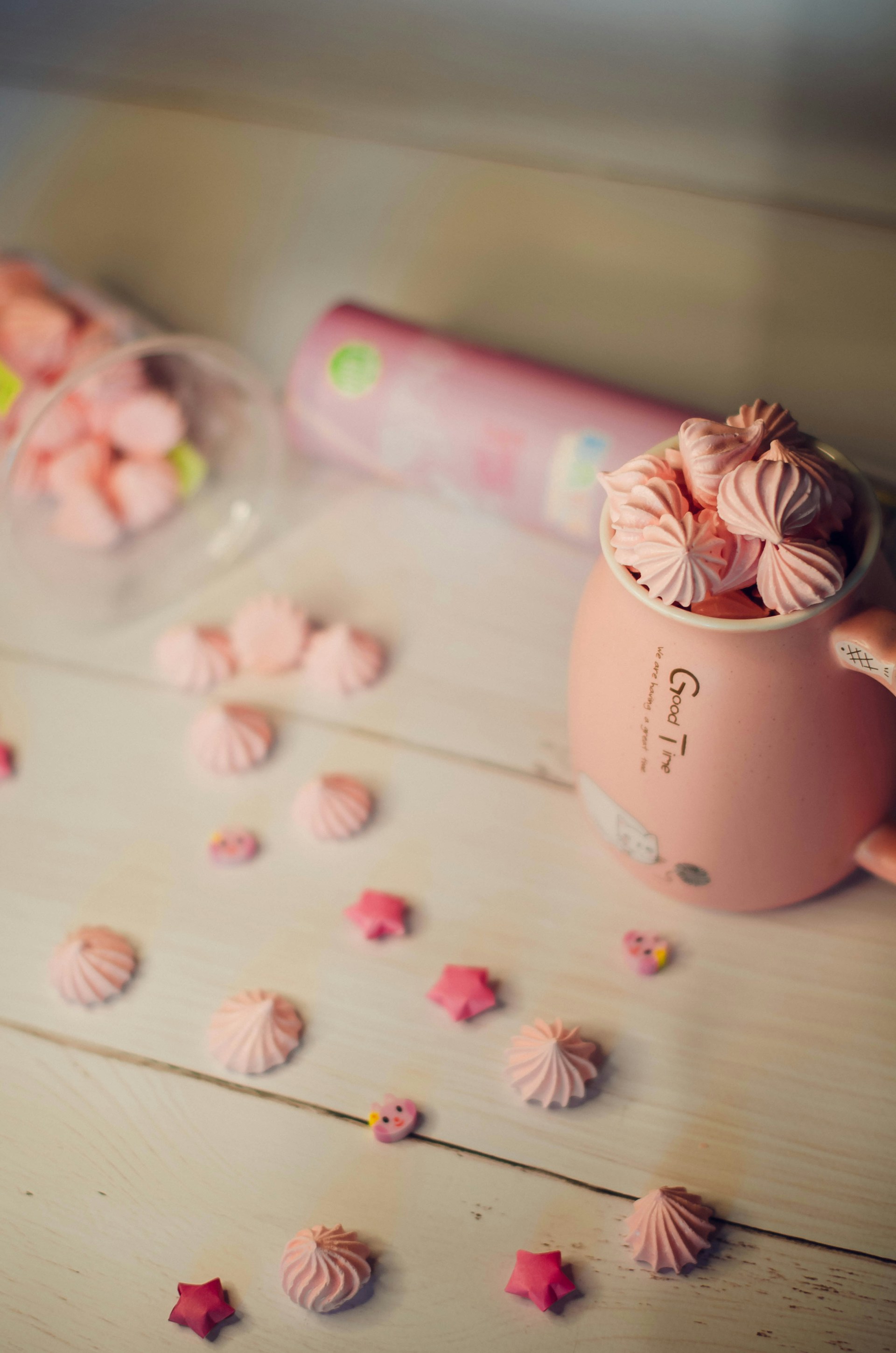 white ceramic mug on white and pink floral textile