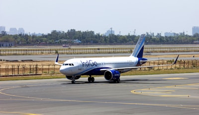 white and blue passenger plane on airport during daytime