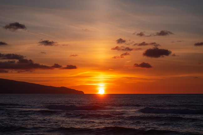 body of water during sunset