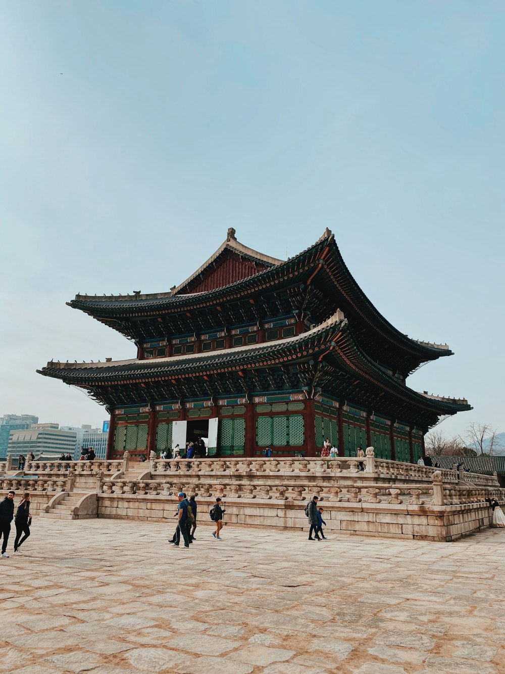 people walking on street near red and brown temple during daytime