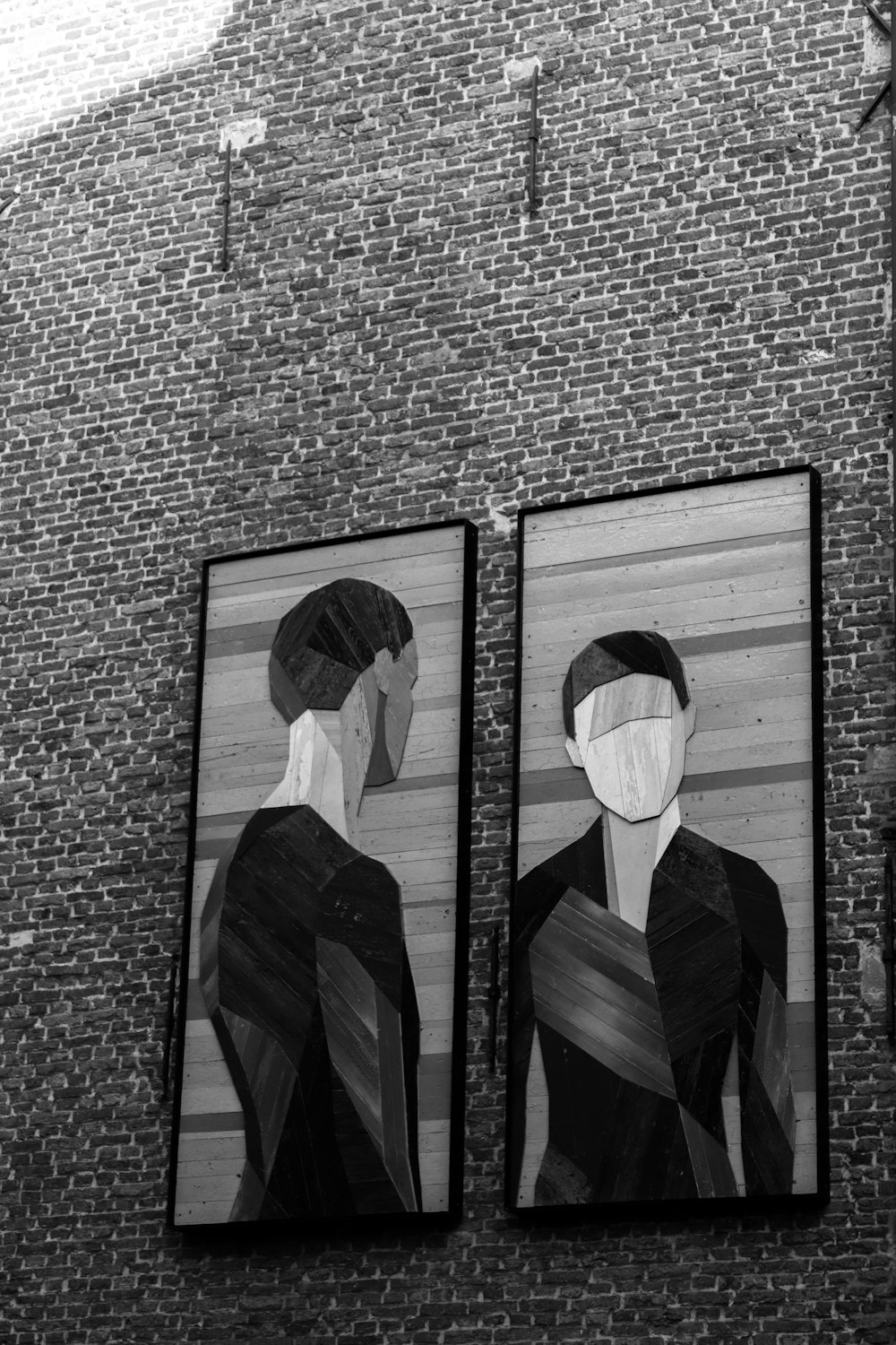 man and woman in black suit standing in front of black and white photo frame