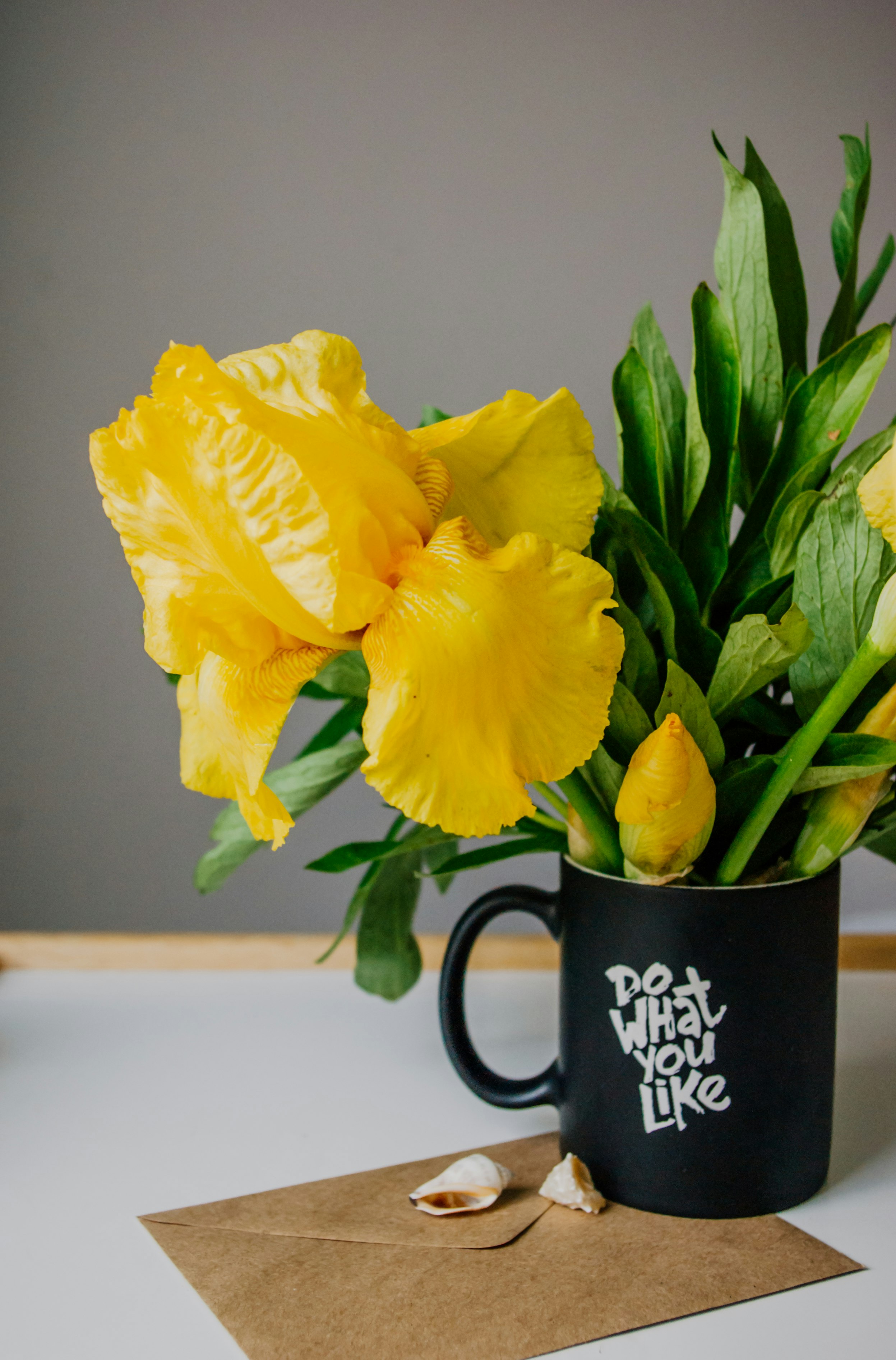 yellow flower on black ceramic mug