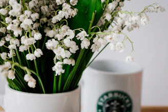 Close-up of a personalized mug featuring a delicate lily of the valley design.