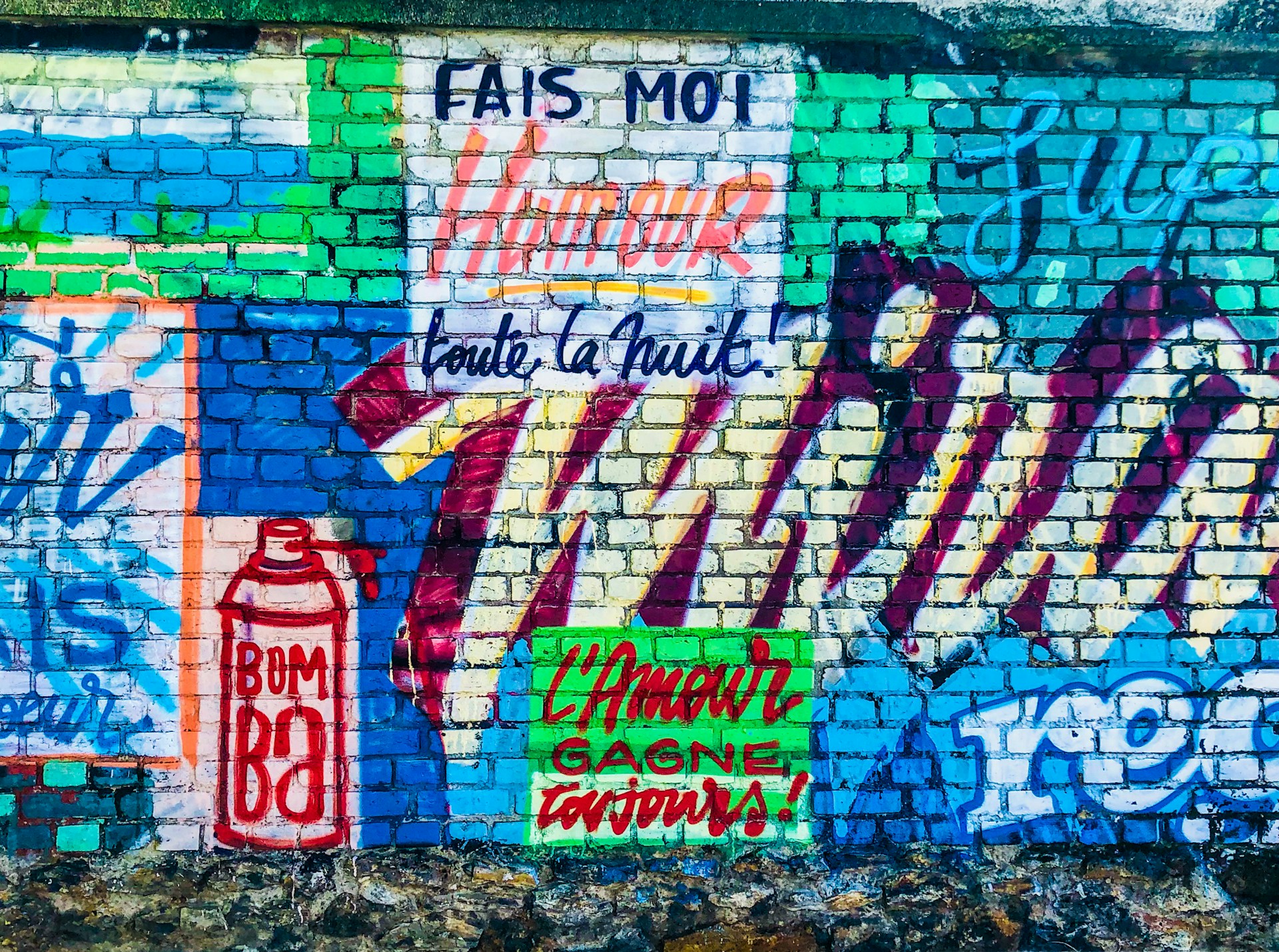 red blue and white graffiti on wall