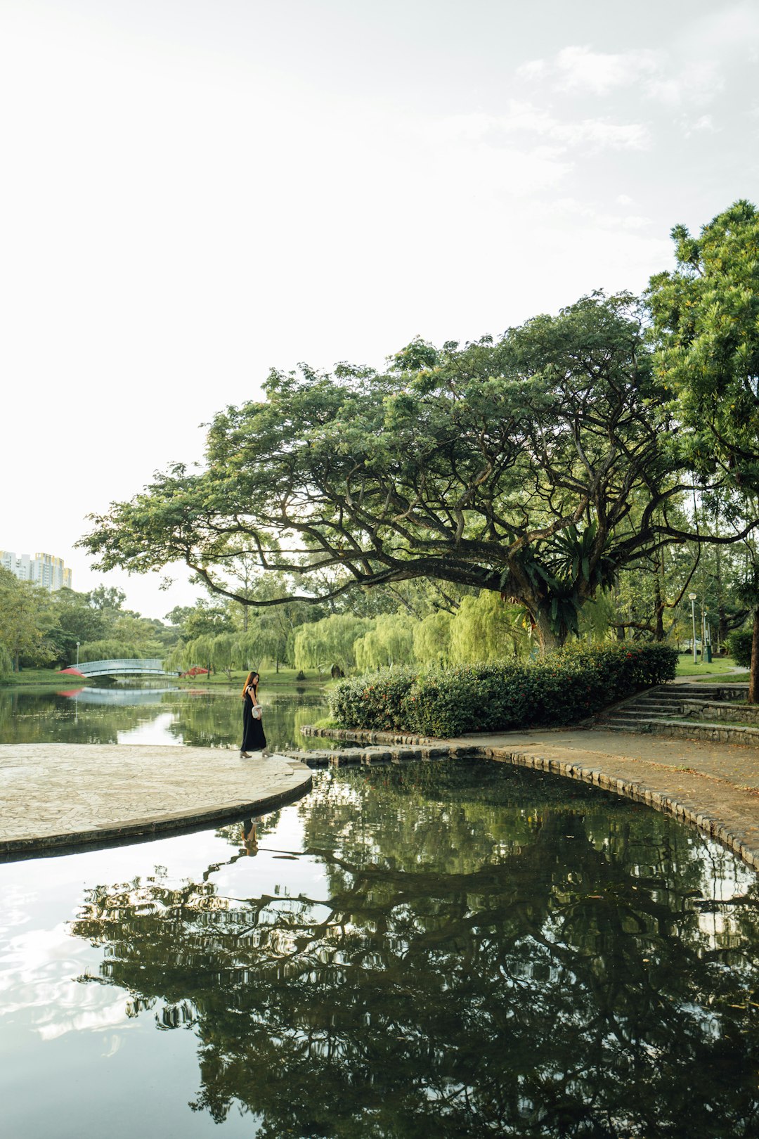 people walking on brown concrete bridge over river during daytime