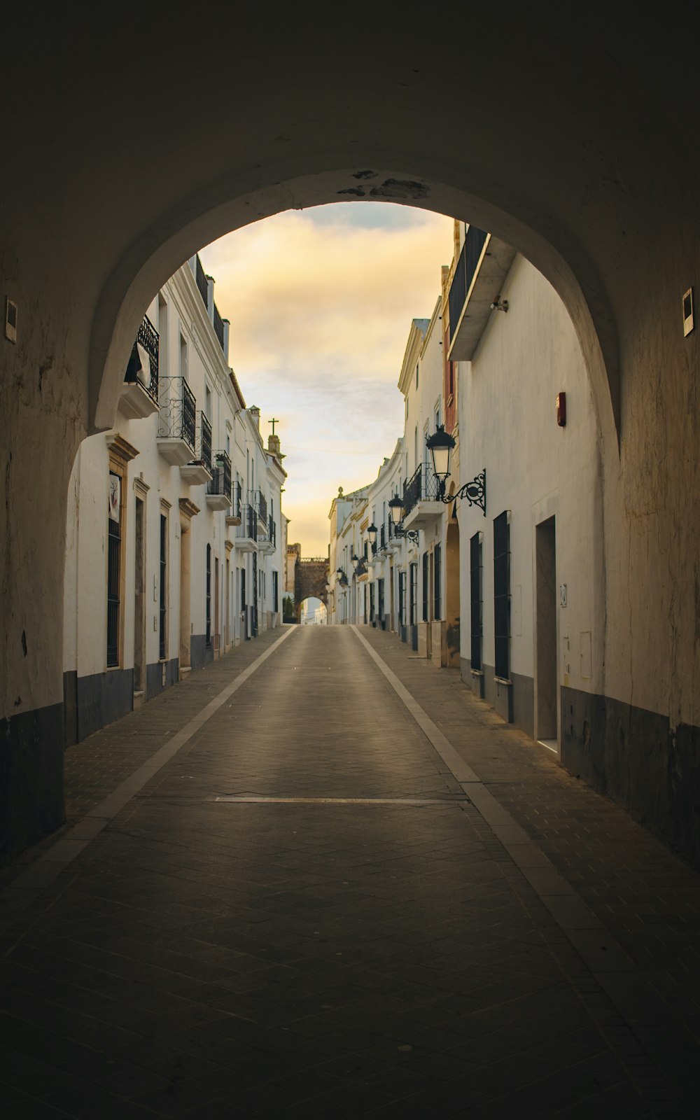 empty hallway between concrete buildings during daytime