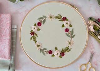 white and red floral round plate