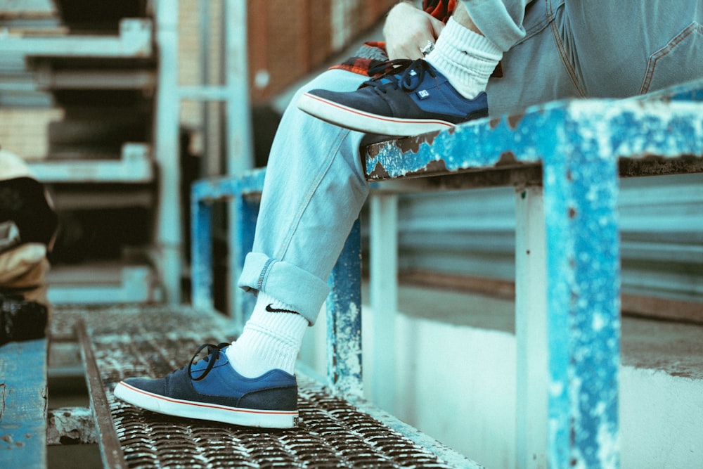 Person in blue denim jeans and white nike sneakers standing on gray  concrete pathway photo – Free Chicago Image on Unsplash