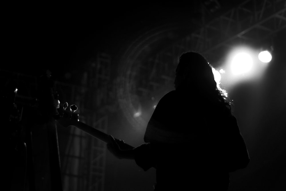 silhouette of man playing guitar