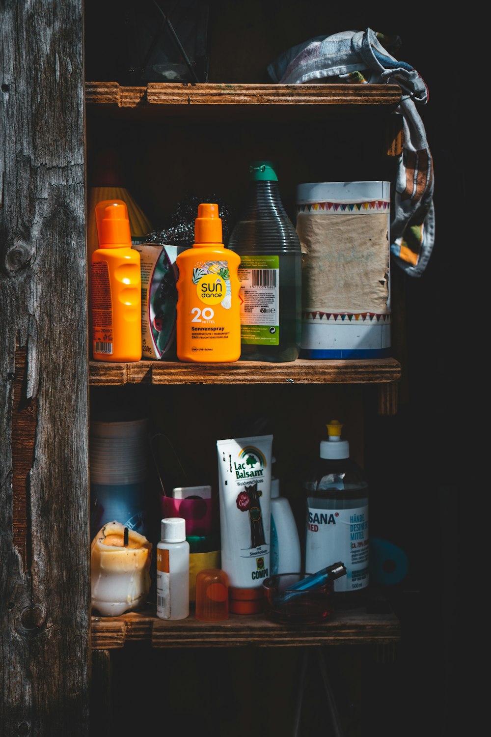 assorted bottles on brown wooden shelf
