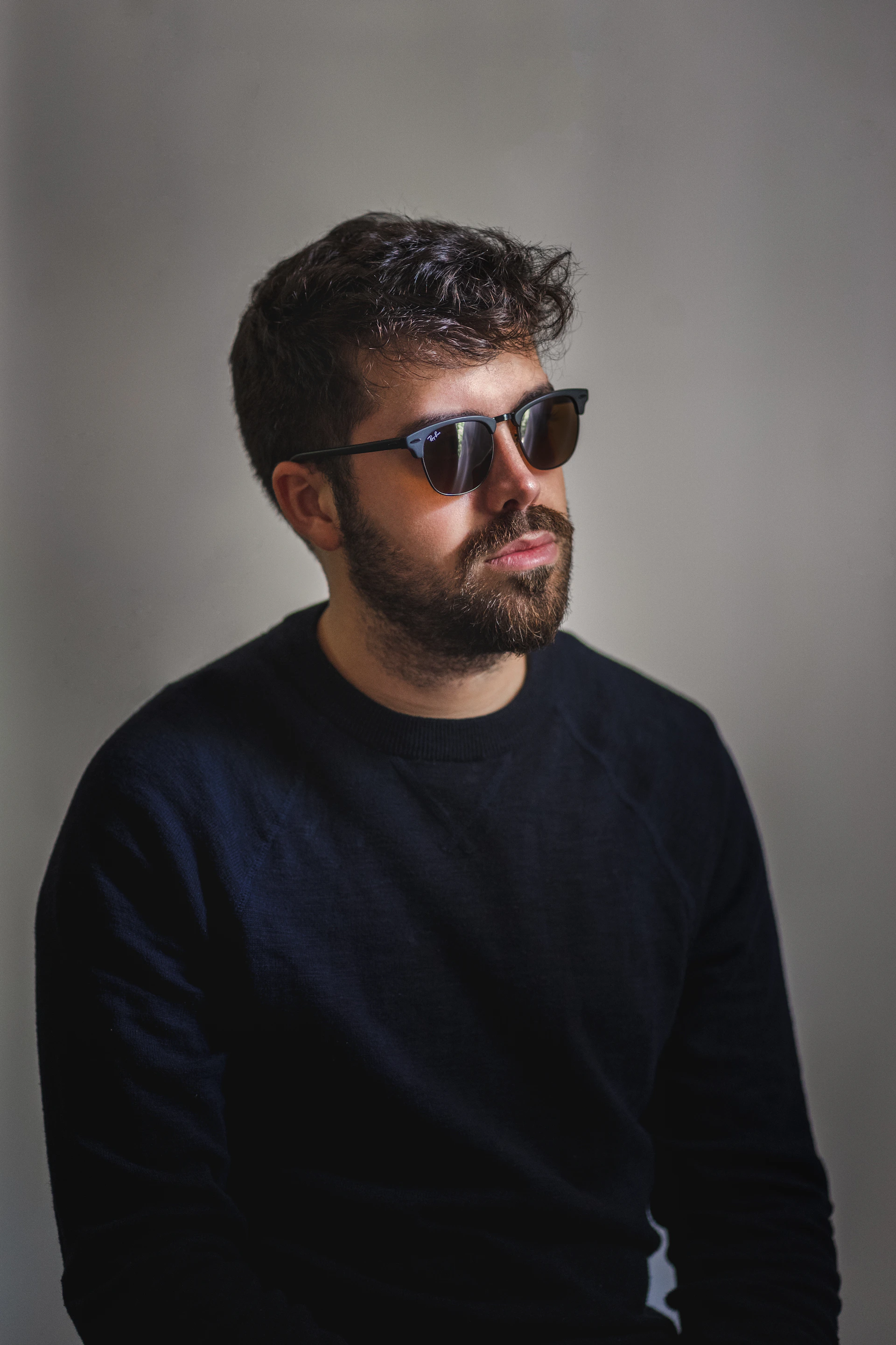 man in black crew neck shirt wearing black sunglasses