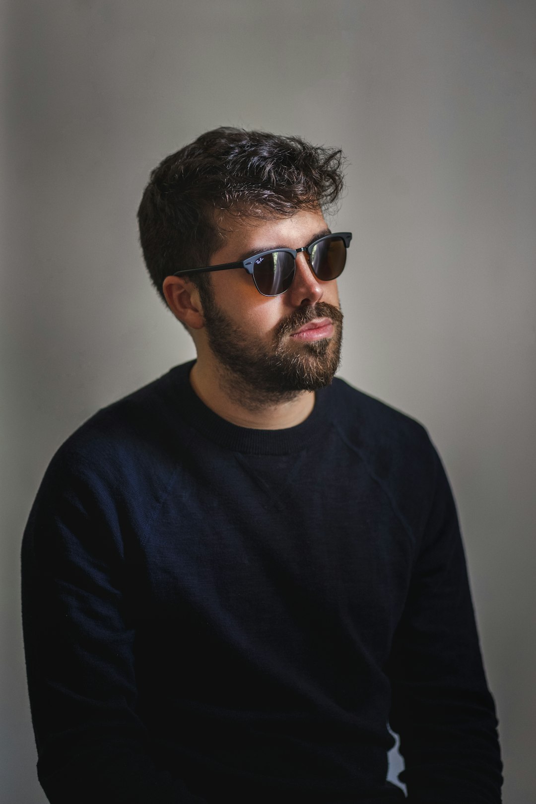 man in black crew neck shirt wearing black sunglasses