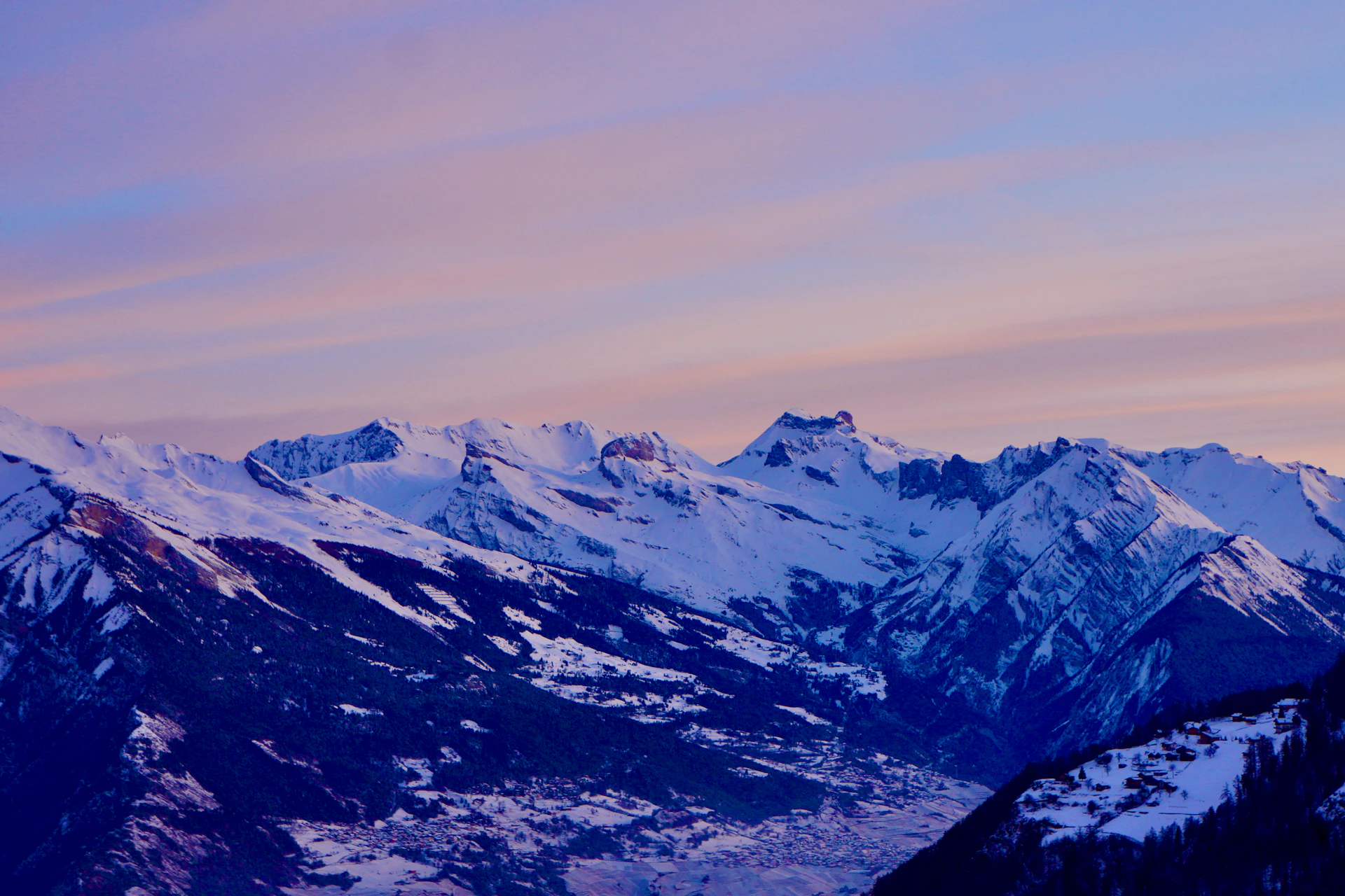 A serene image showing snow-covered slopes of an ice mountain at twilight, with soft pastel colors fading into the horizon.