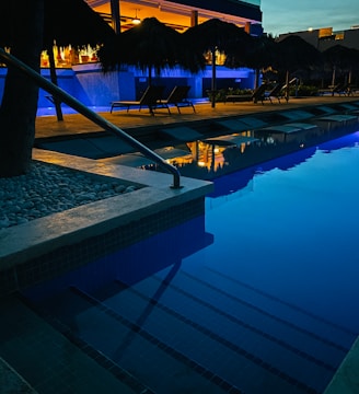 swimming pool near trees during night time