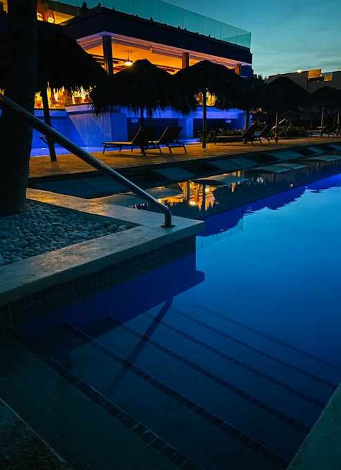 swimming pool near trees during night time