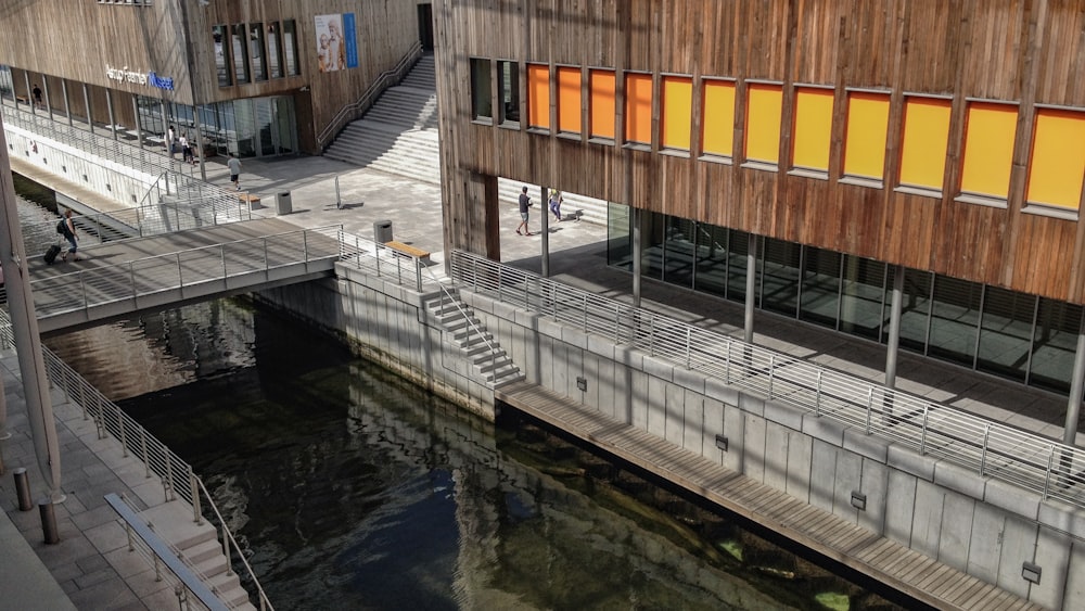 brown and white wooden bridge over river during daytime