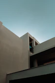 A minimalistic architectural environment featuring glass buildings and power tools with a blue and white palette.