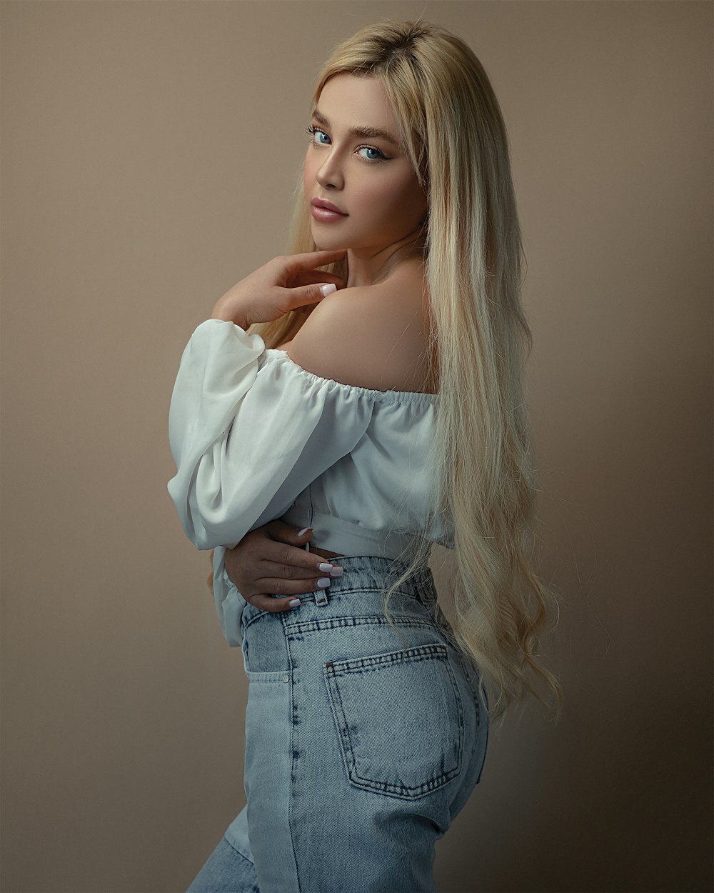 woman in white long sleeve shirt and blue denim jeans