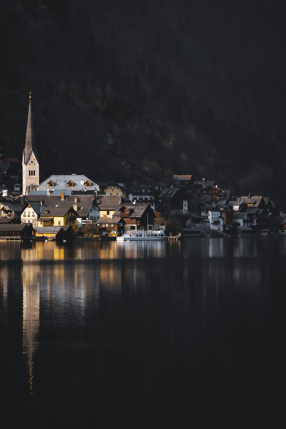 white and brown concrete building near body of water during night time