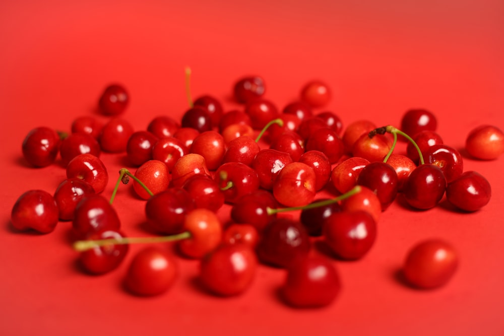 red cherry fruits on red surface
