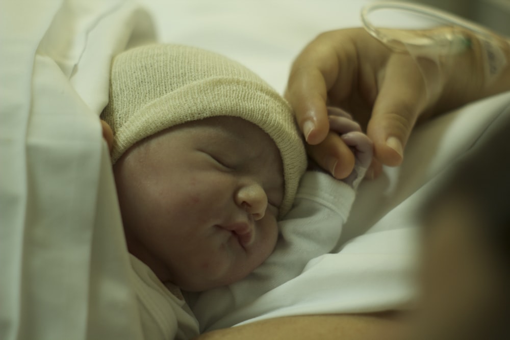 baby in green knit cap