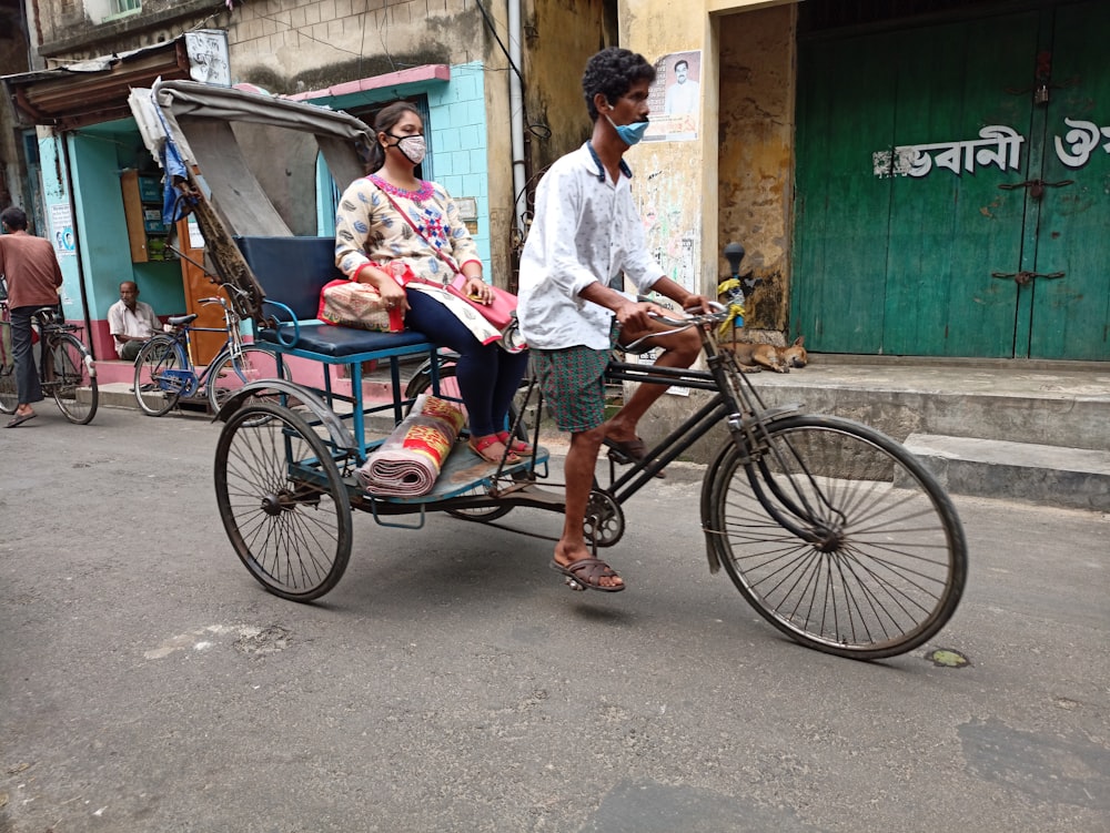 man in white dress shirt riding on red and black trike