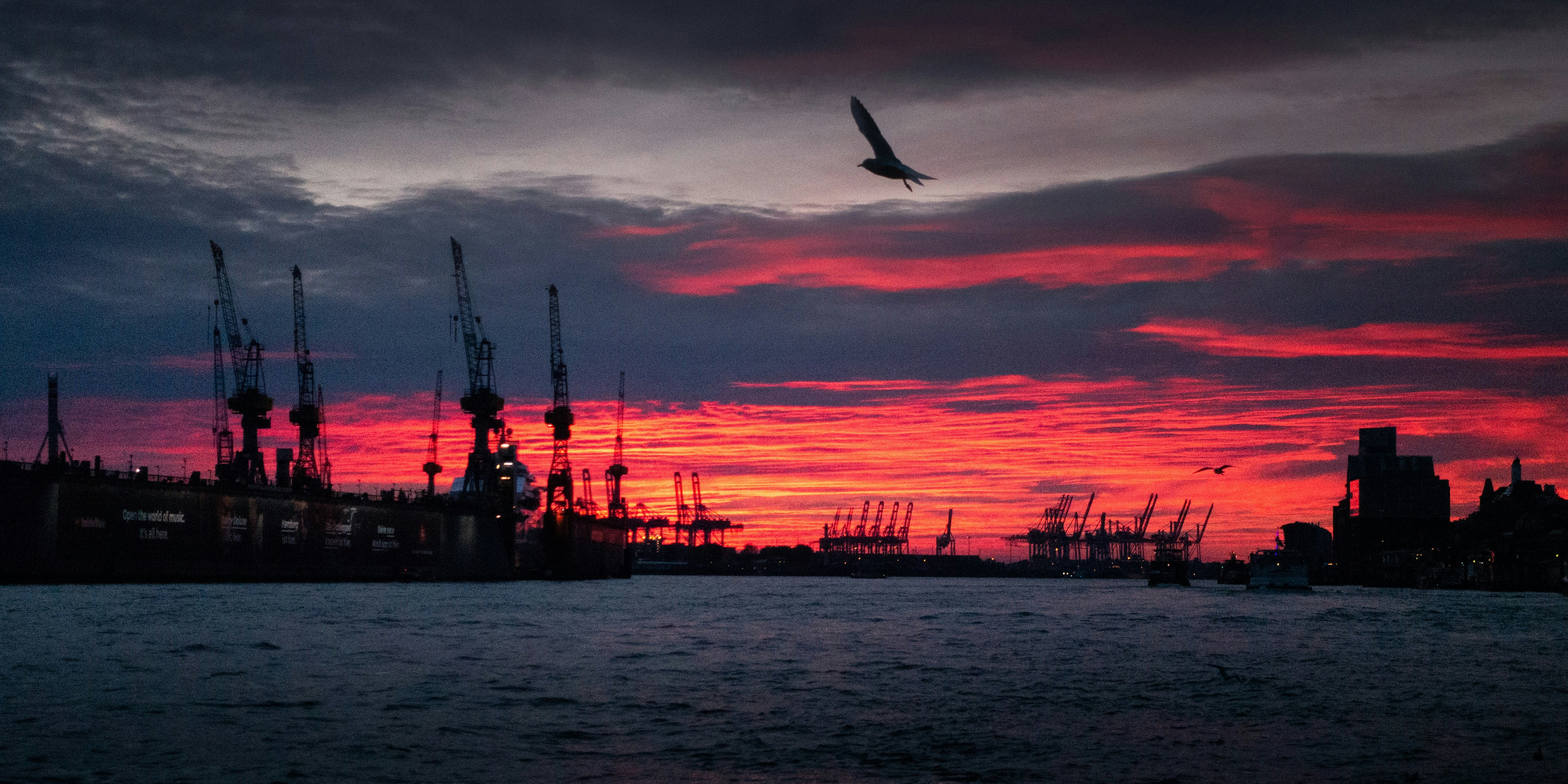 silhouette of ship on sea during sunset