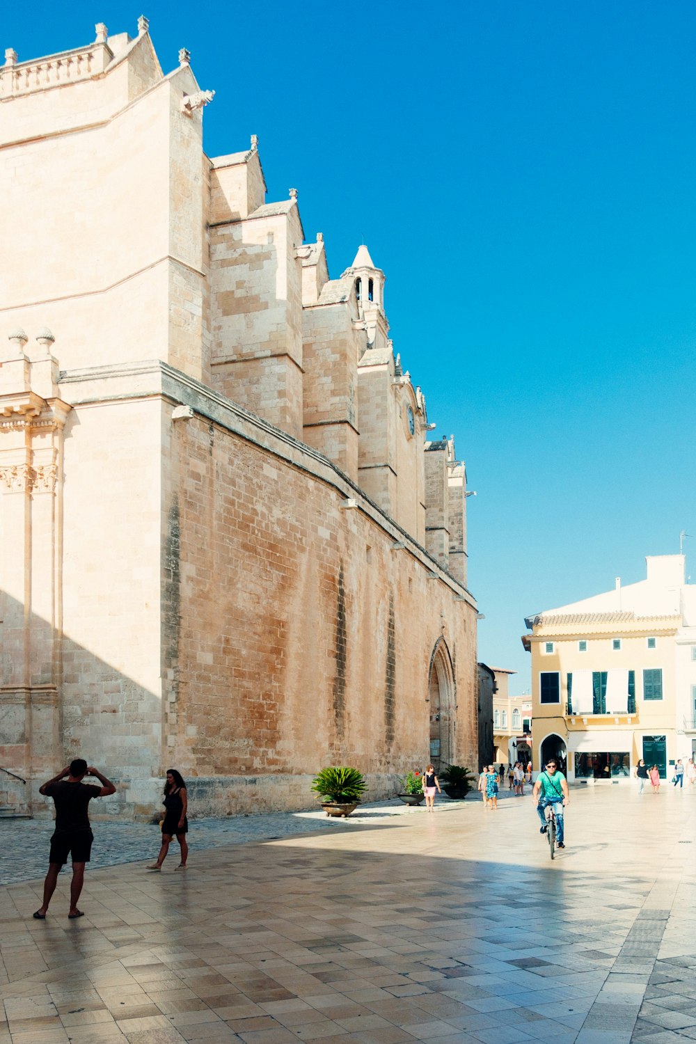 people walking on street near brown concrete building during daytime