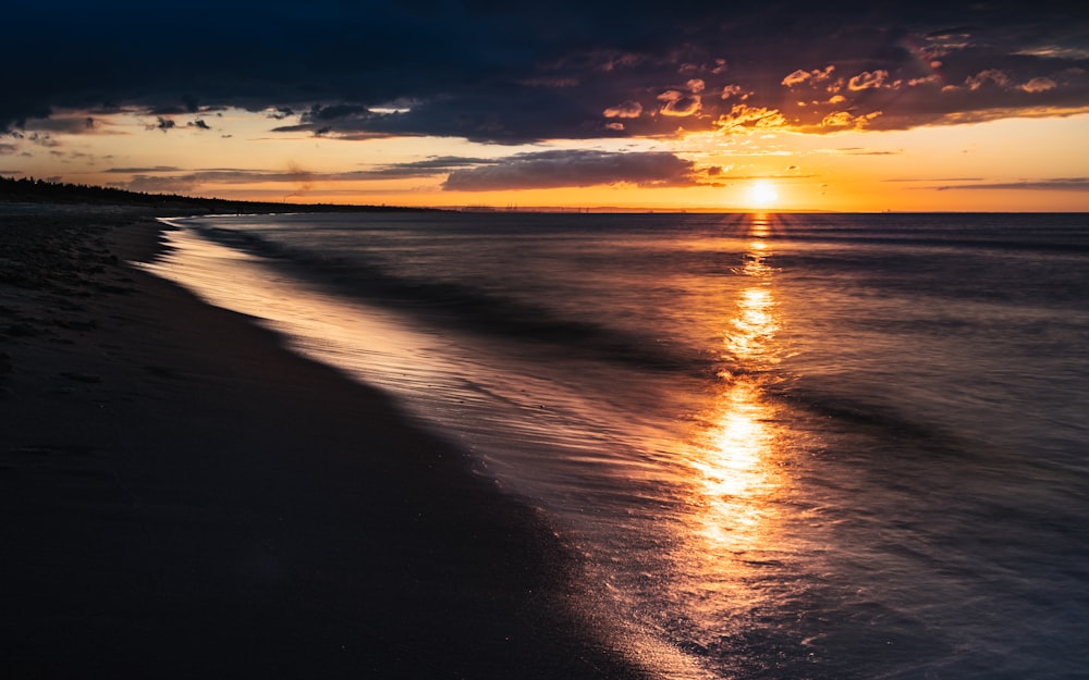 body of water during sunset