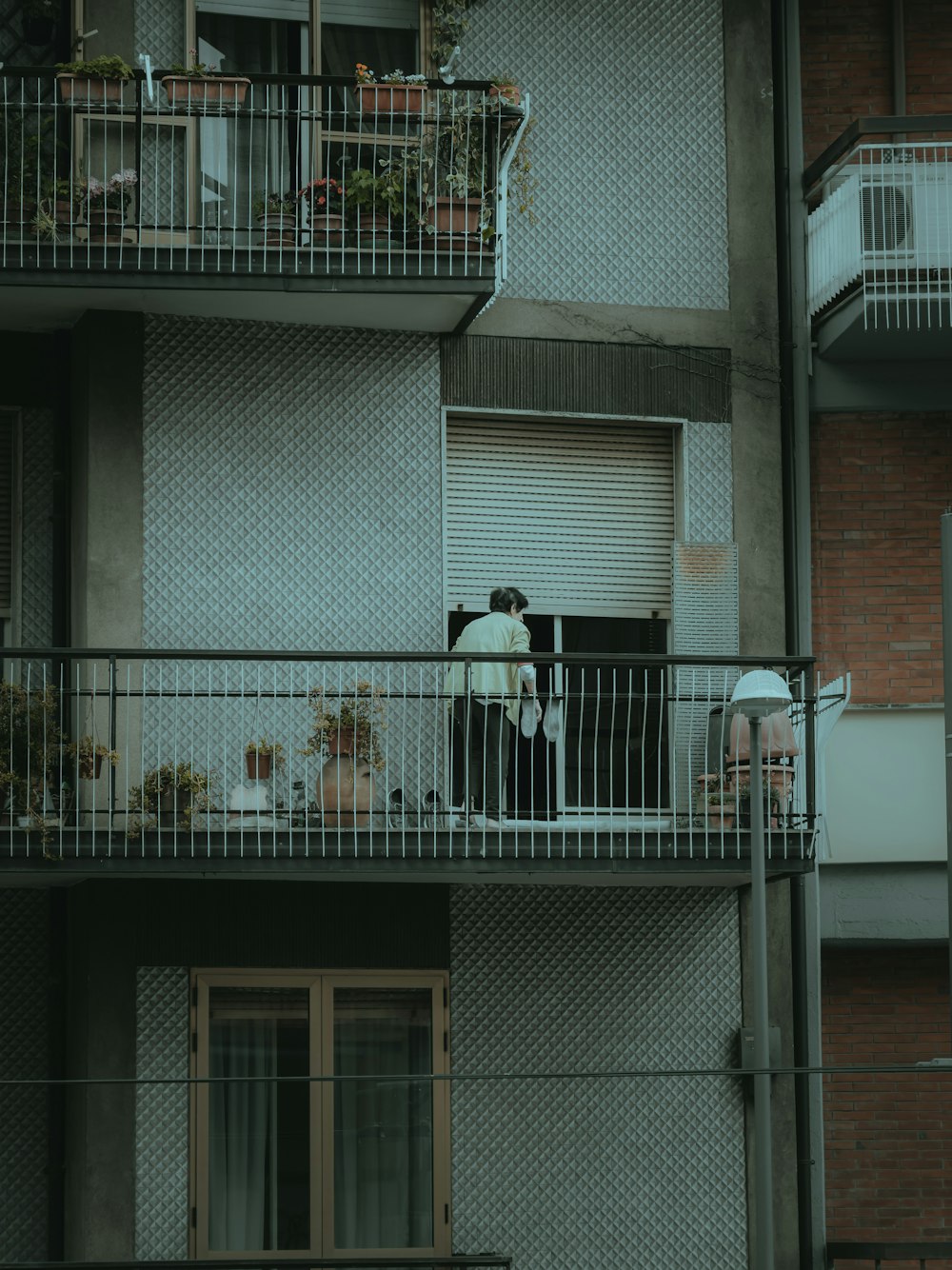 man in black jacket standing on white concrete staircase